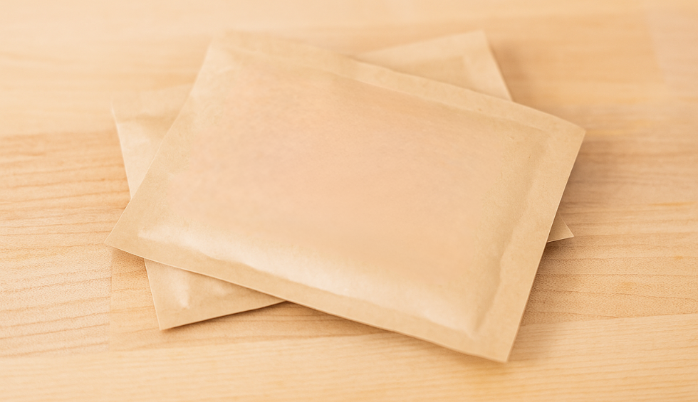 Humidity packs placed on a wooden surface, ideal for preserving freshness in a pound of bud