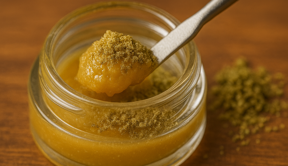 Close-up of dry sift rosin concentrate in a glass jar, with kief sprinkled on top and a dab tool scooping the golden rosin extract
