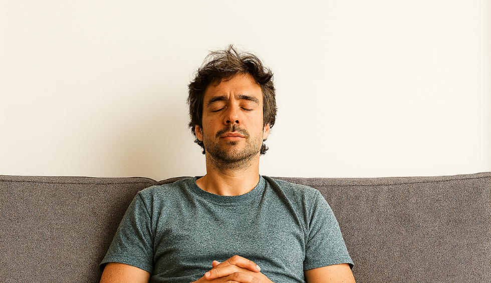 Man relaxing with eyes closed on couch, reflecting the calming and uplifting effects of the Pineapple Express strain
