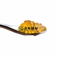 Bruce Banner OG cannabis caviar on spoon with bright golden oil bubbles