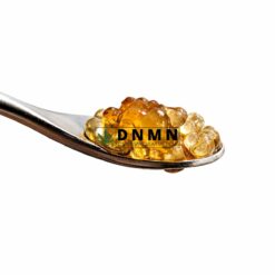 Grape Ape cannabis caviar extract on spoon with glossy golden oil coating